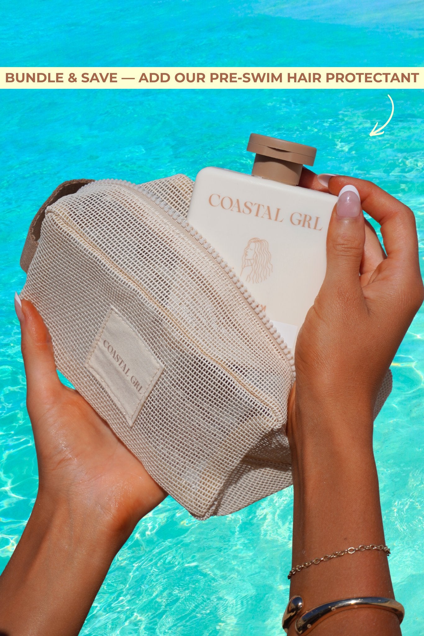 Two hands holding a mesh bag with a bottle labeled 'Coastal Girl' against a blue water background.